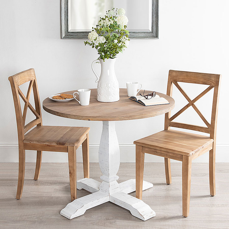 Wooden table with chairs and floral feature
