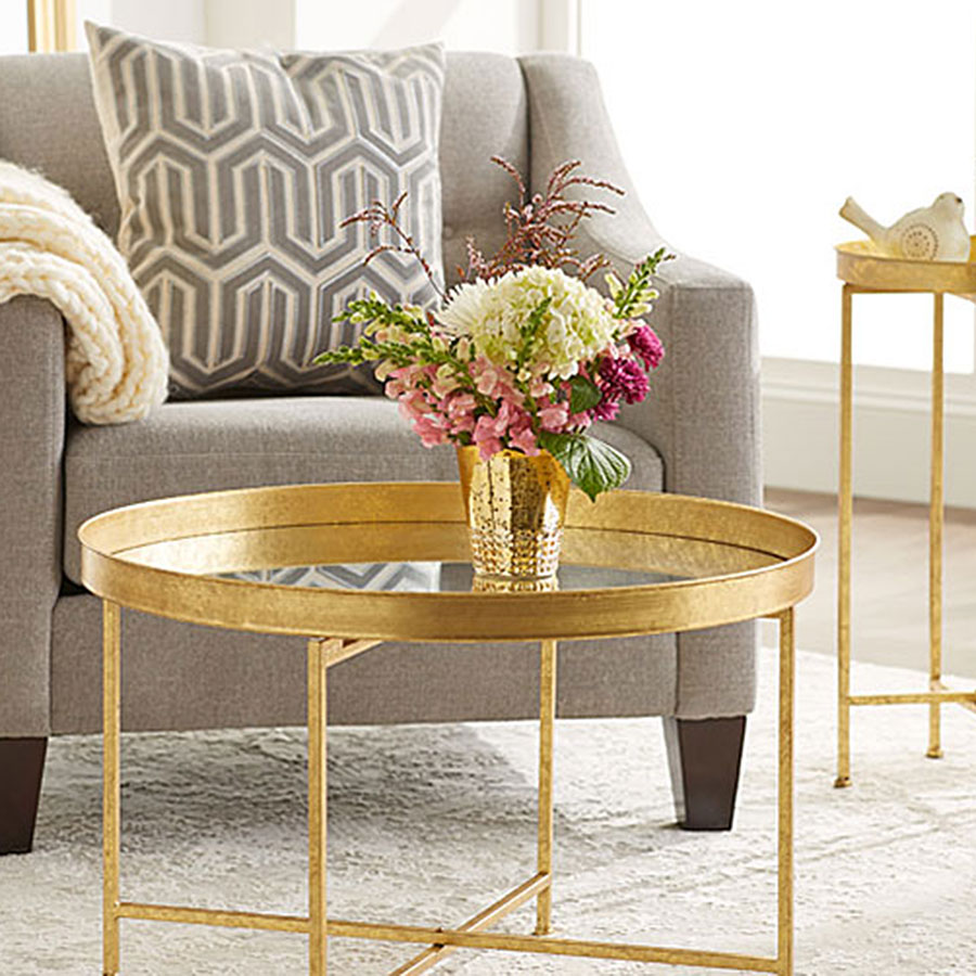 Golden metal table with floral feature atop
